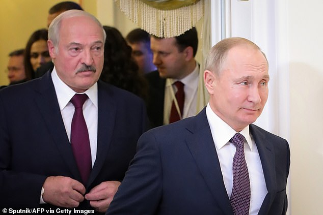 This file photo taken on December 20, 2019 shows Russian President Vladimir Putin (right) followed by Belarusian President Alexander Lukashenko (left), entering a meeting hall during the Supreme Eurasian Economic Council, in Saint Petersburg