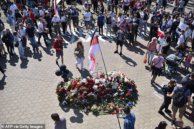 People lay flowers near the Pushkinskaya subway station where Alexander Taraikovsky, a 34-year-old protester died on August 10, in central Minsk, on August 15, 2020, during the funeral ceremony