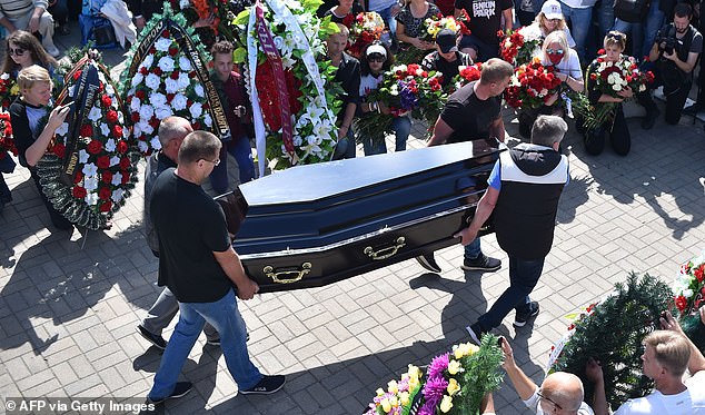 Men carry a coffin with the body of Alexander Taraikovsky, a 34-year-old protester who died on August 10, during the funeral ceremony in central Minsk today