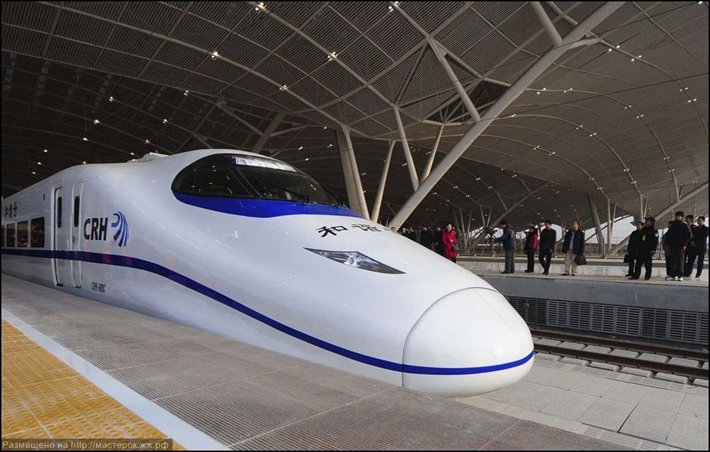 A labourer cleans the floor beside a China Railway High-speed train preparing for the operation ceremony from Wuhan to Guangzhou in Wuha n