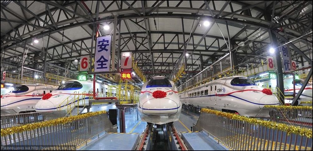 A labourer cleans the floor beside a China Railway High-speed train preparing for the operation ceremony from Wuhan to Guangzhou in Wuha n