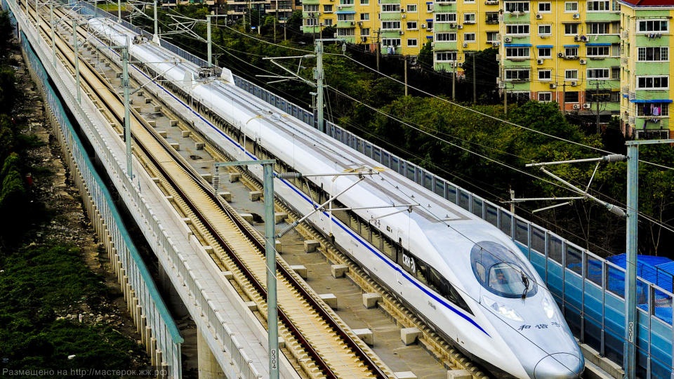 A labourer cleans the floor beside a China Railway High-speed train preparing for the operation ceremony from Wuhan to Guangzhou in Wuha n