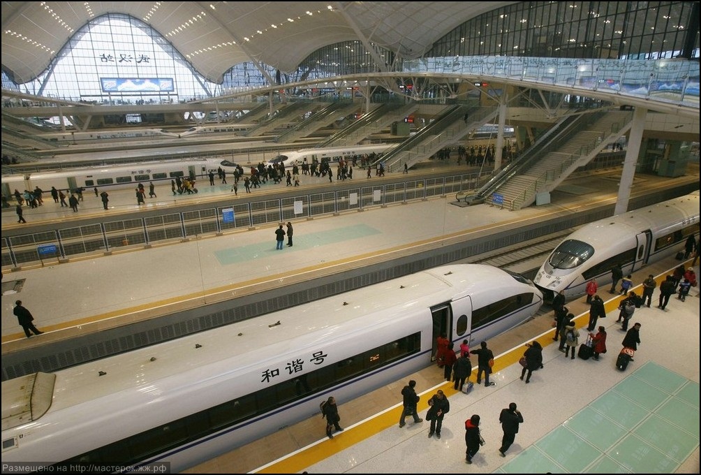 Travellers board a high-speed train which heads to Guangzhou in Wuhan